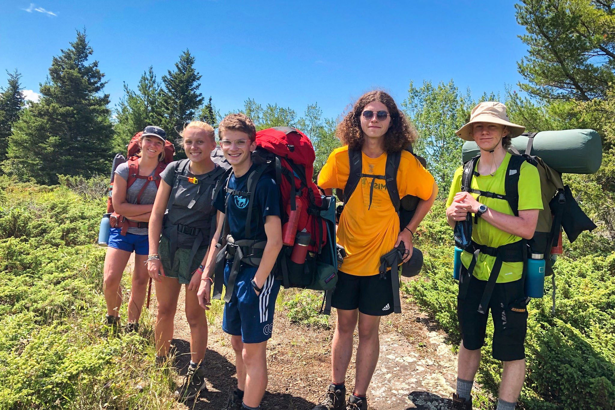 Group of teen backpackers at adventure camp