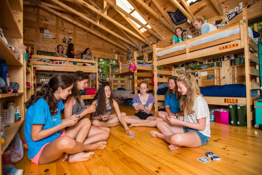 Girls playing cards inside cabin