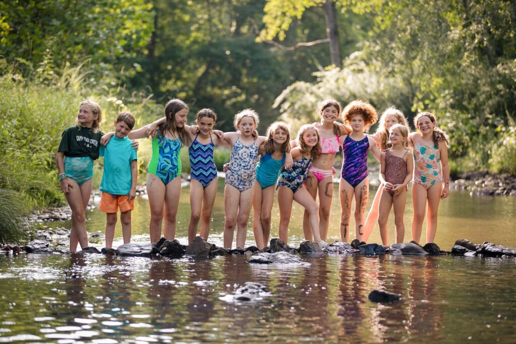 Campers playing in a creek