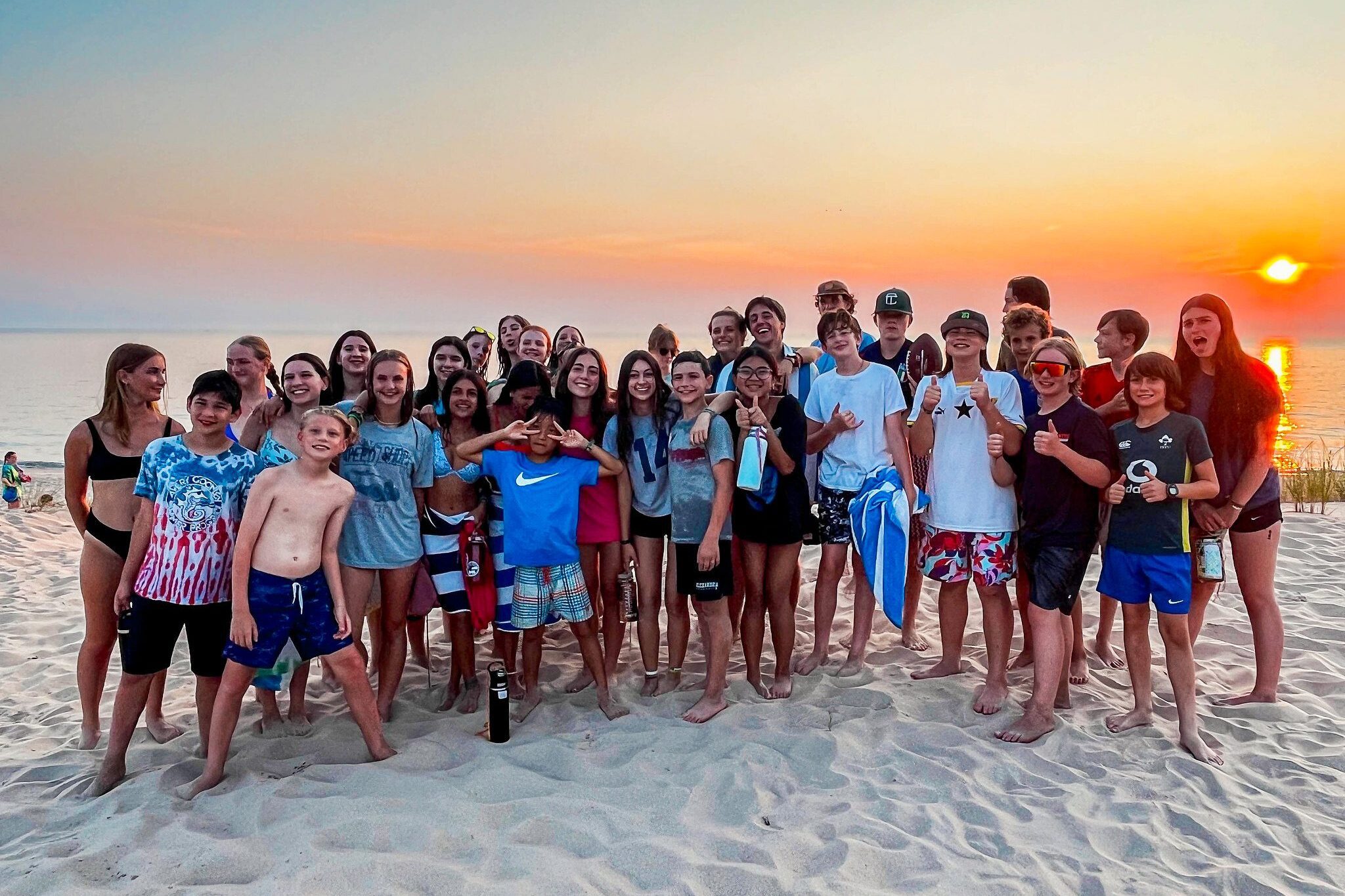 Group of teens at the beach during sunset